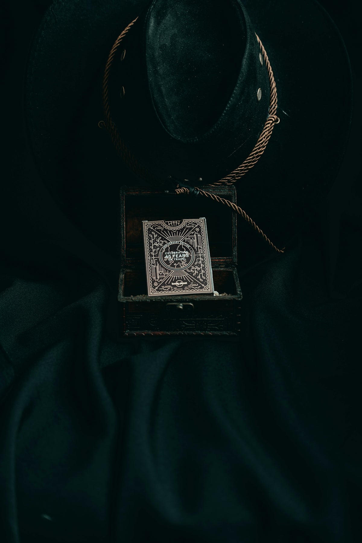 a hat and a playing card in a box