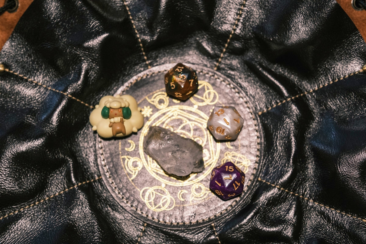 Dice and an amulet rest on a table.